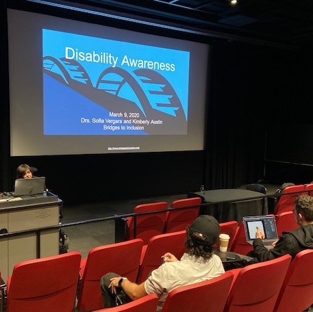 Facilitators presenting in an auditorium 